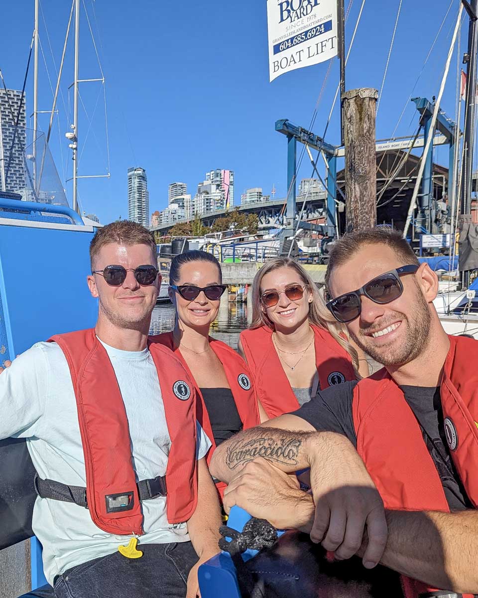 Bailey and Daniel smile with friends on the zodiac boat Vancouver, Canada