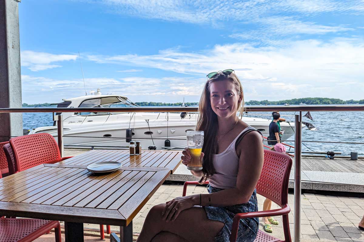 Bailey enjoys a craft beer along the water in Toronto in summer