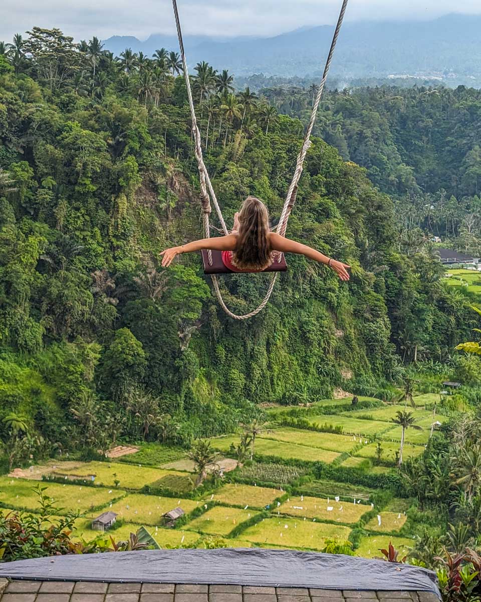 Bailey enjoys a swing over the rice fields in Ubud Bali on a tour