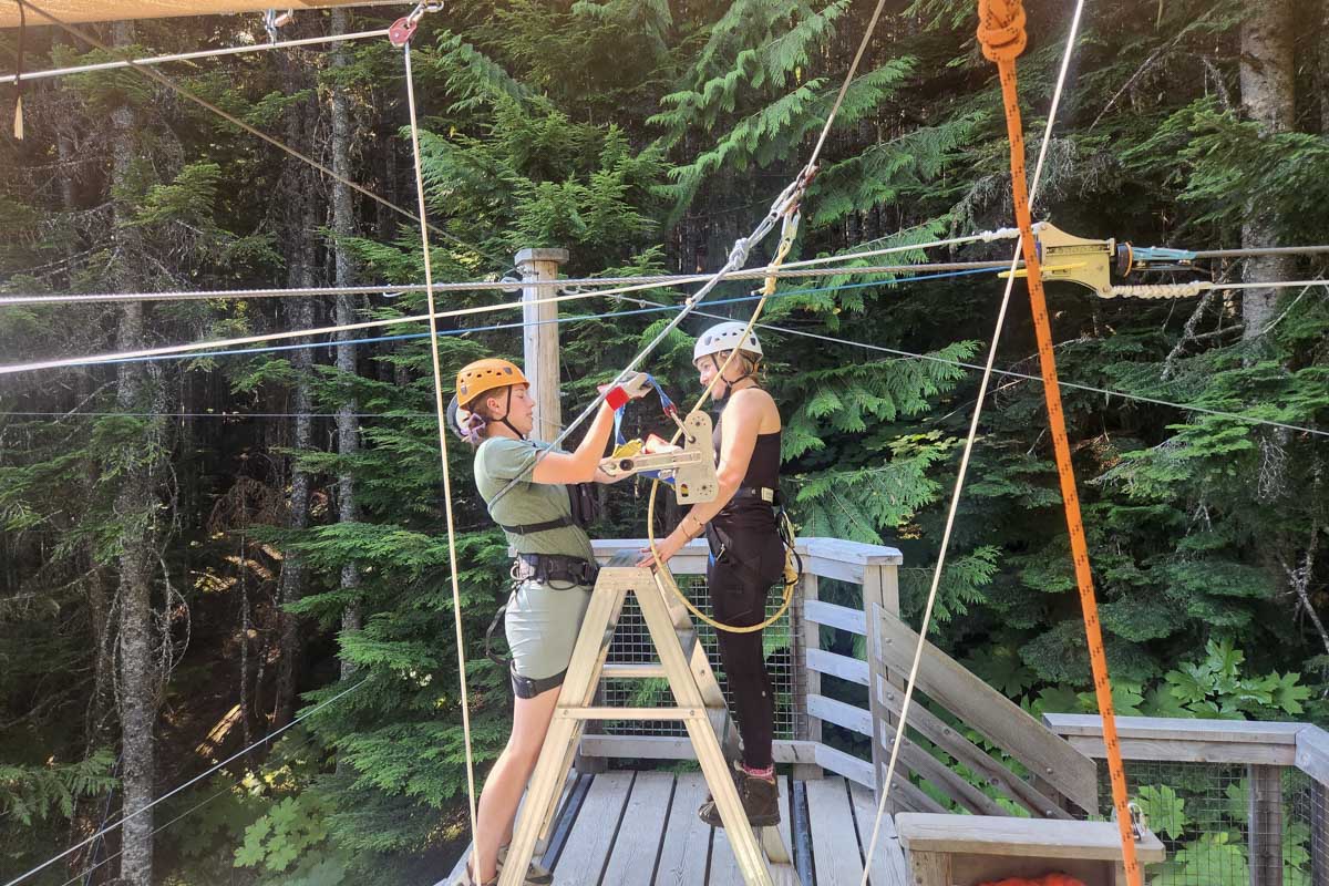 Bailey getting unhitched from the zipline after coming down whistler, canada, sasquatch zipline