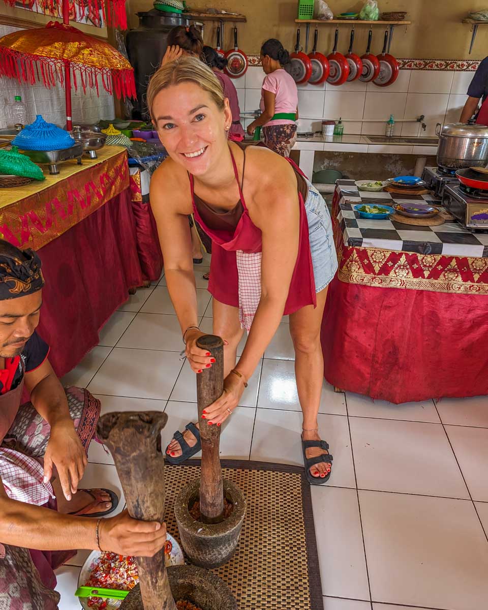 Bailey grinds down ingredients during a cooking class in Bali