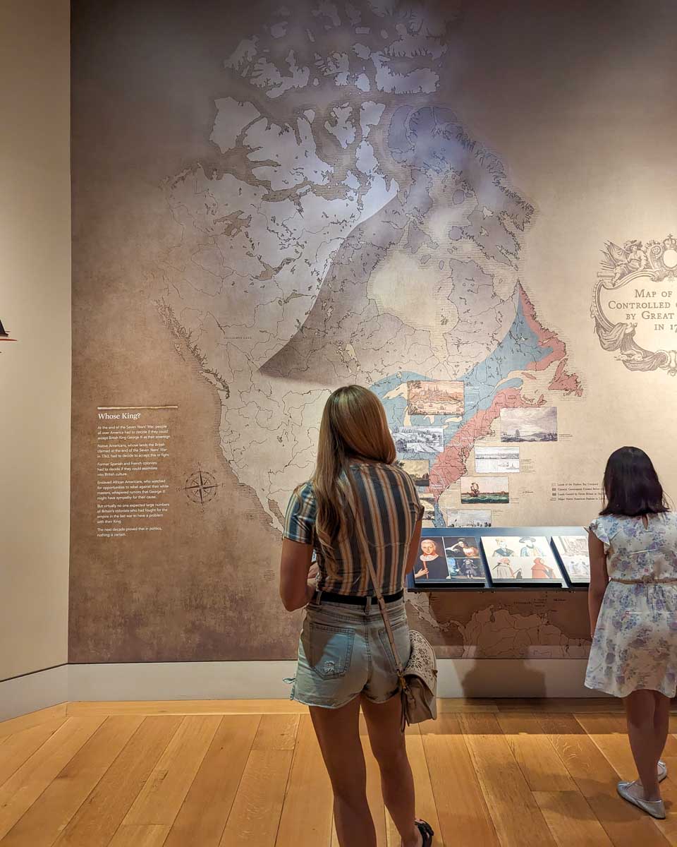 Bailey looking at a map at museum of the american revolution