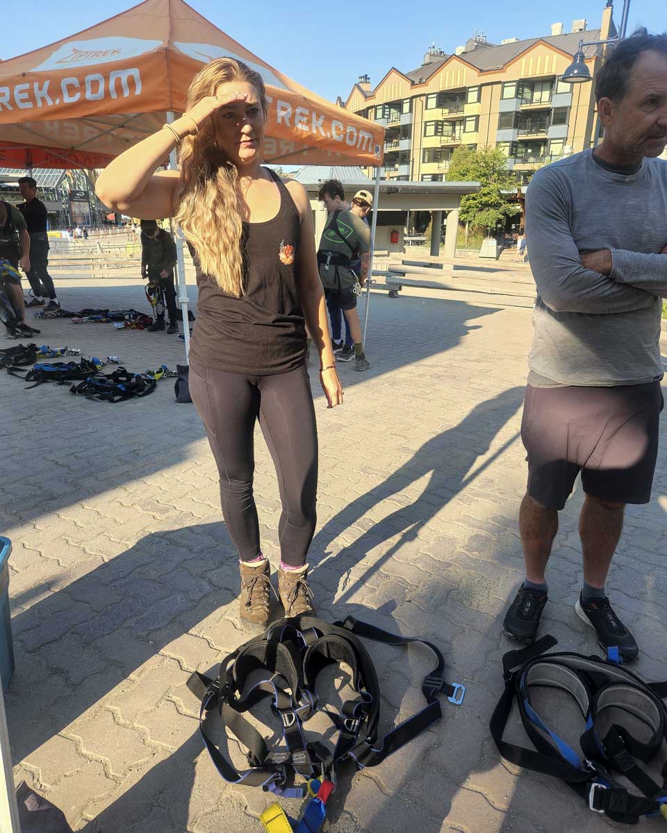 Bailey stands near zipline gear at whistler, canada, sasquatch zipline