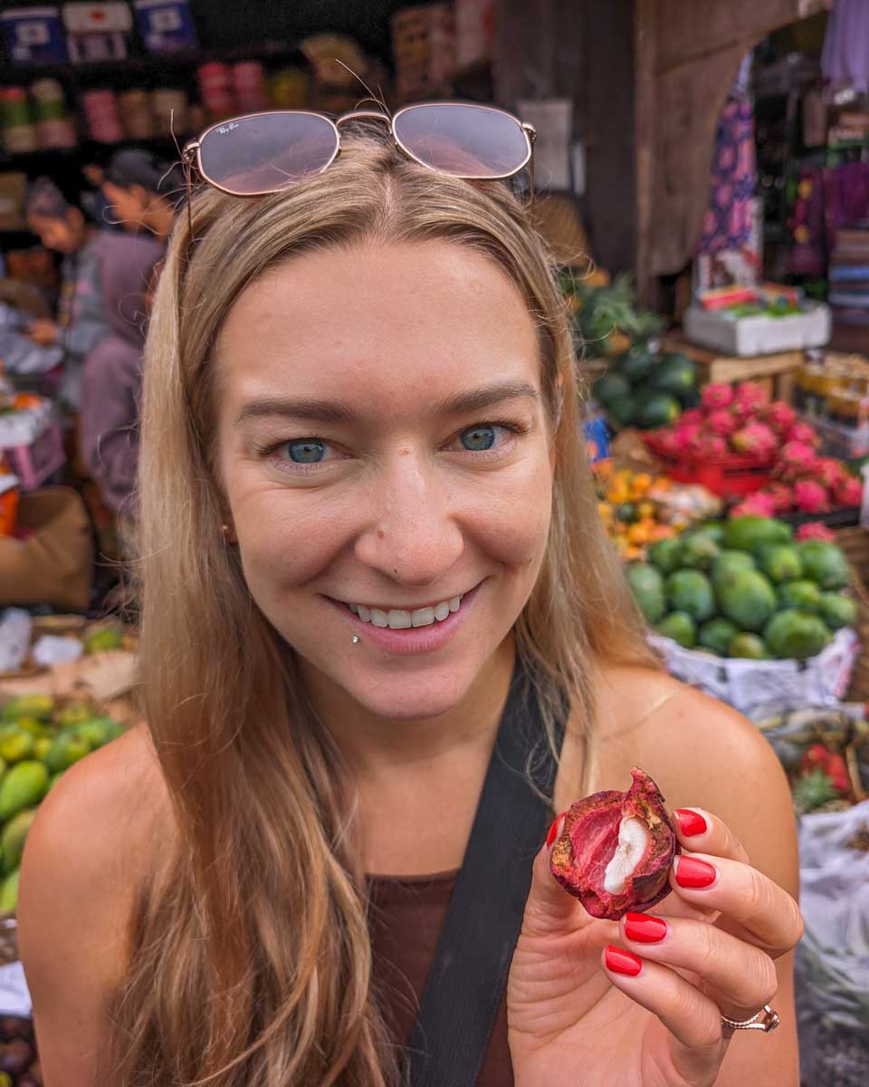 Bailey trys some fruit during a market tour on a cooking class in Bali
