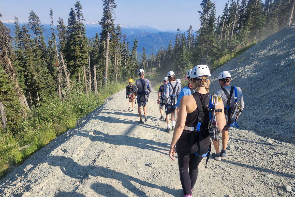 Bailey walking down a path towards the zipline whistler, canada, sasquatch zipline
