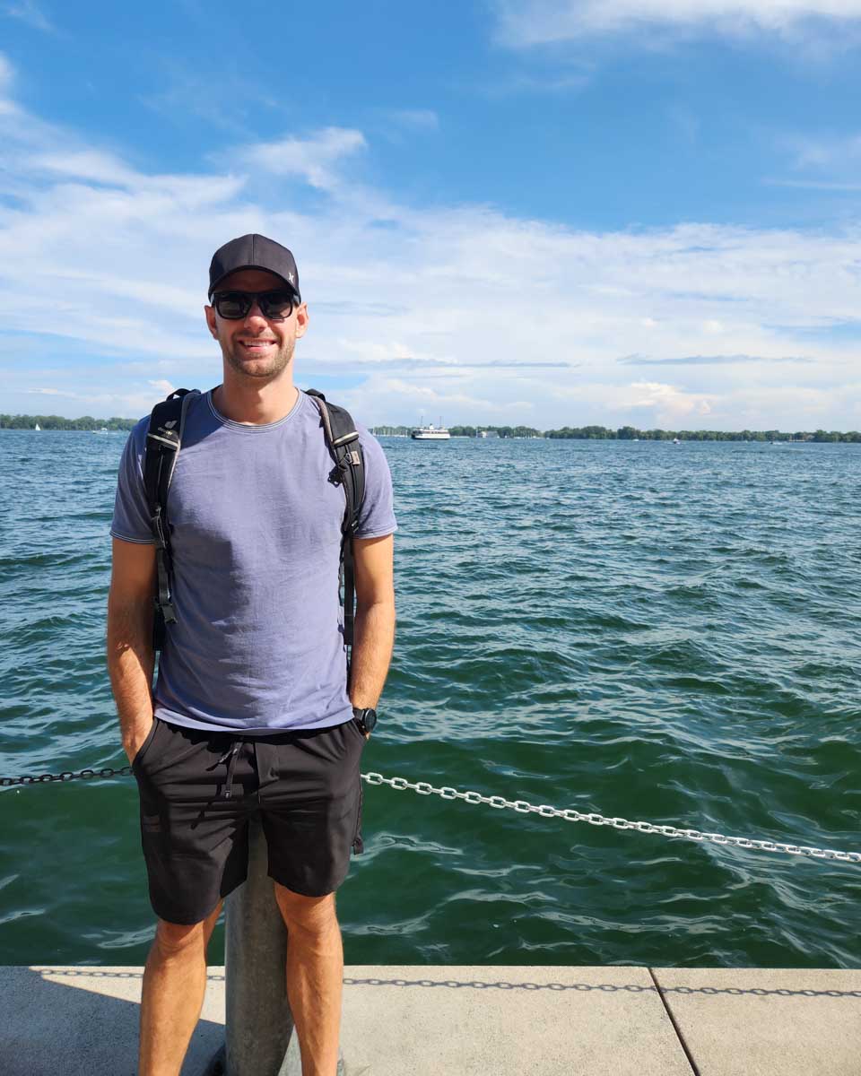 Daniel poses for a photo along the waterfront in Toronto