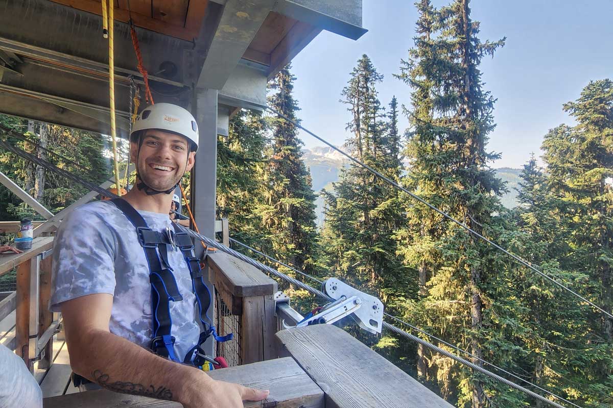 Daniel smiles for a photo in his zipline gear whistler, canada, sasquatch zipline