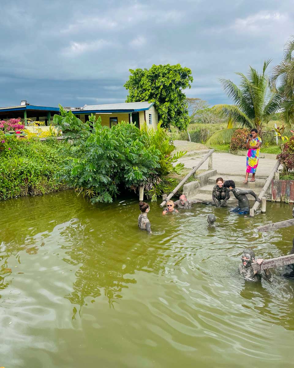People getting into a hot spring to rinse off mud at Sabeto Mud Pools and Hot Springs fiji