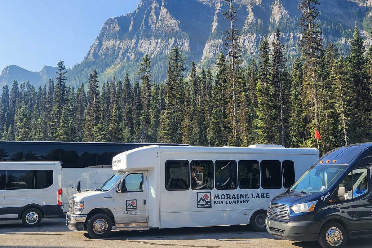 The Moraine Lake Bus Company Shuttle parked in a Parking lot Moraine Lake Canada
