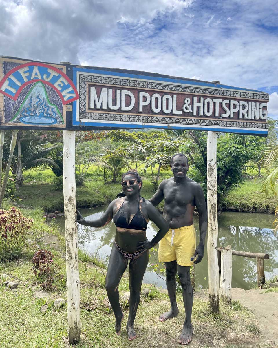 Two people smiling at the tifajek mud pool hot spring fiji