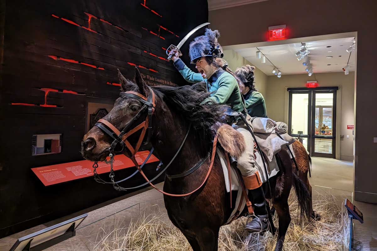 Wax statue of man on a horse yelling with a sword at the museum of the american revolution