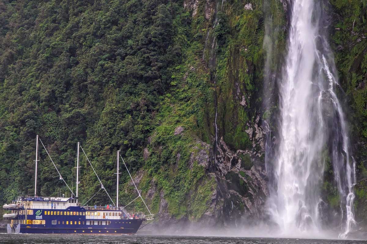 A boat near Bowen Falls on a milford sound cruise new zealand