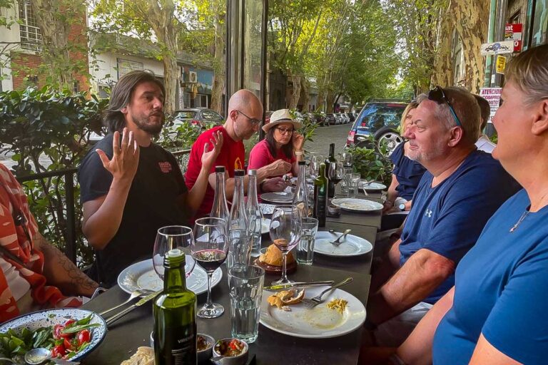 A guide explains the food people are eating on a sherpa food tour in Buenos Aires Argentina
