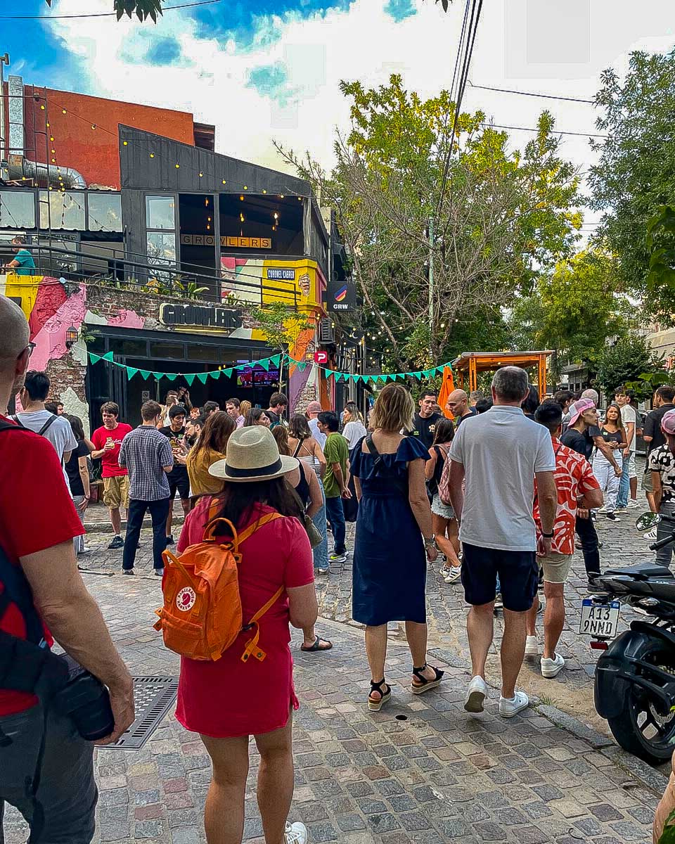 People walk on a colroful street on a sherpa food tour in Buenos Aires Argentina