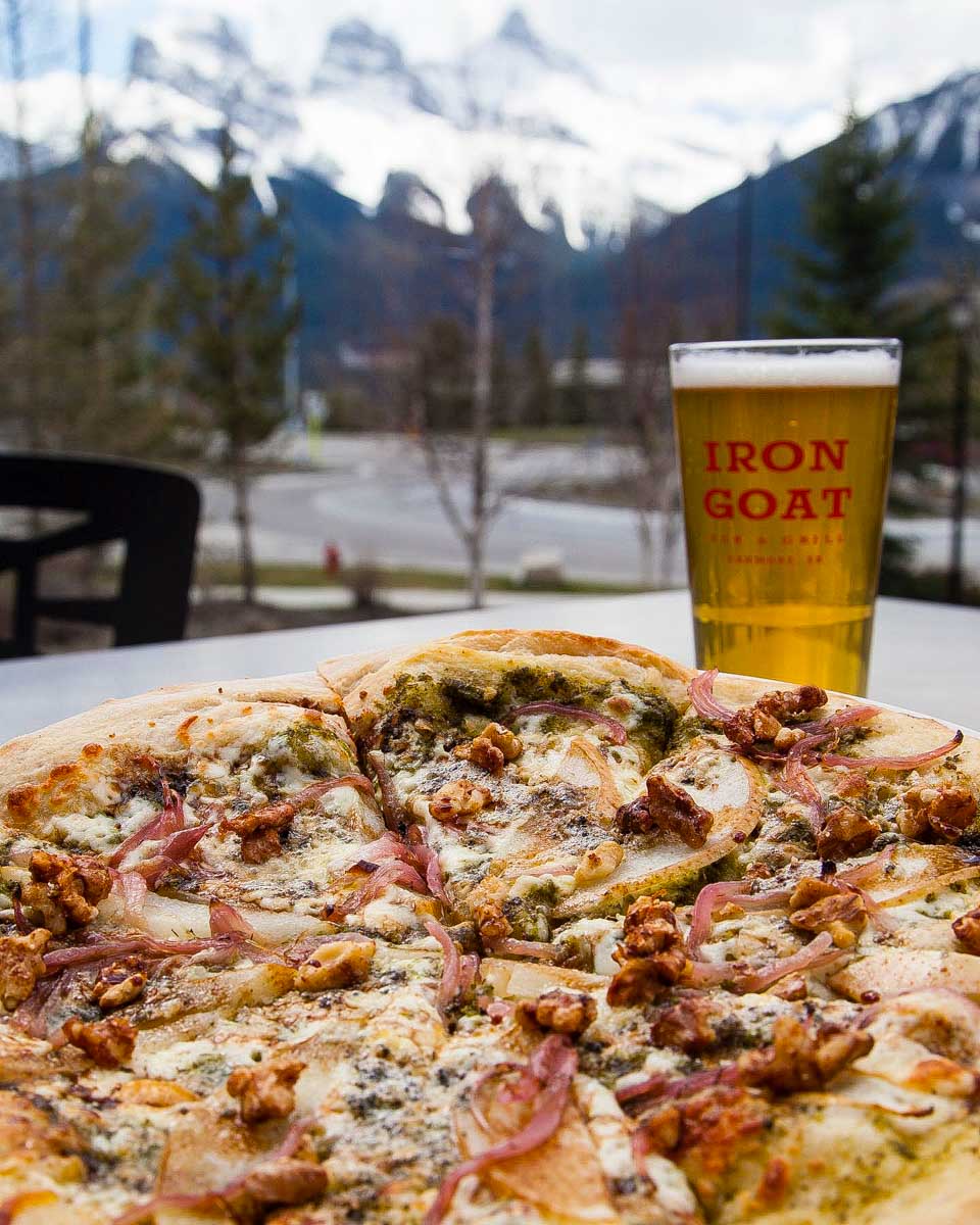 Pizza and beer on the patio of Iron Goat Canmore, Alberta Canada