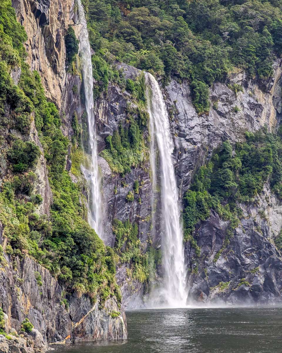 The side of the Milford Sound fjord and waterfall on a cruise New Zealand
