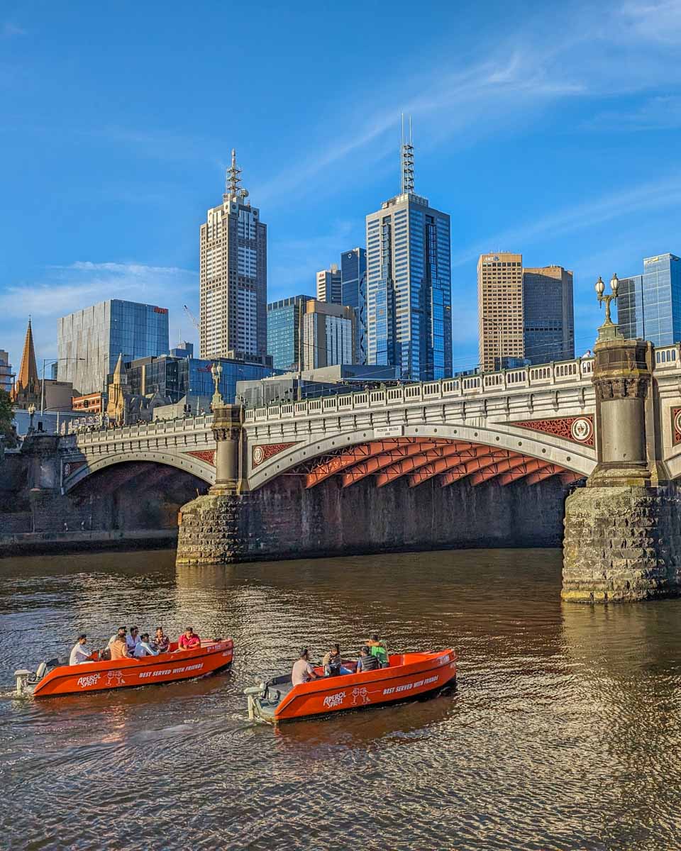 Two boats cruise the Yarra River in Melbourne Australia