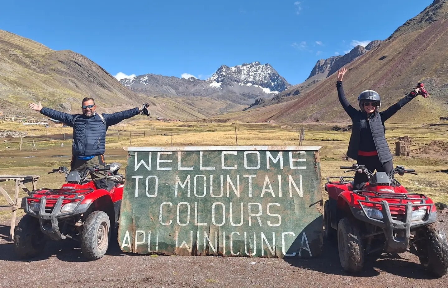 Two people on ATVs on Rainbow Mountain. 