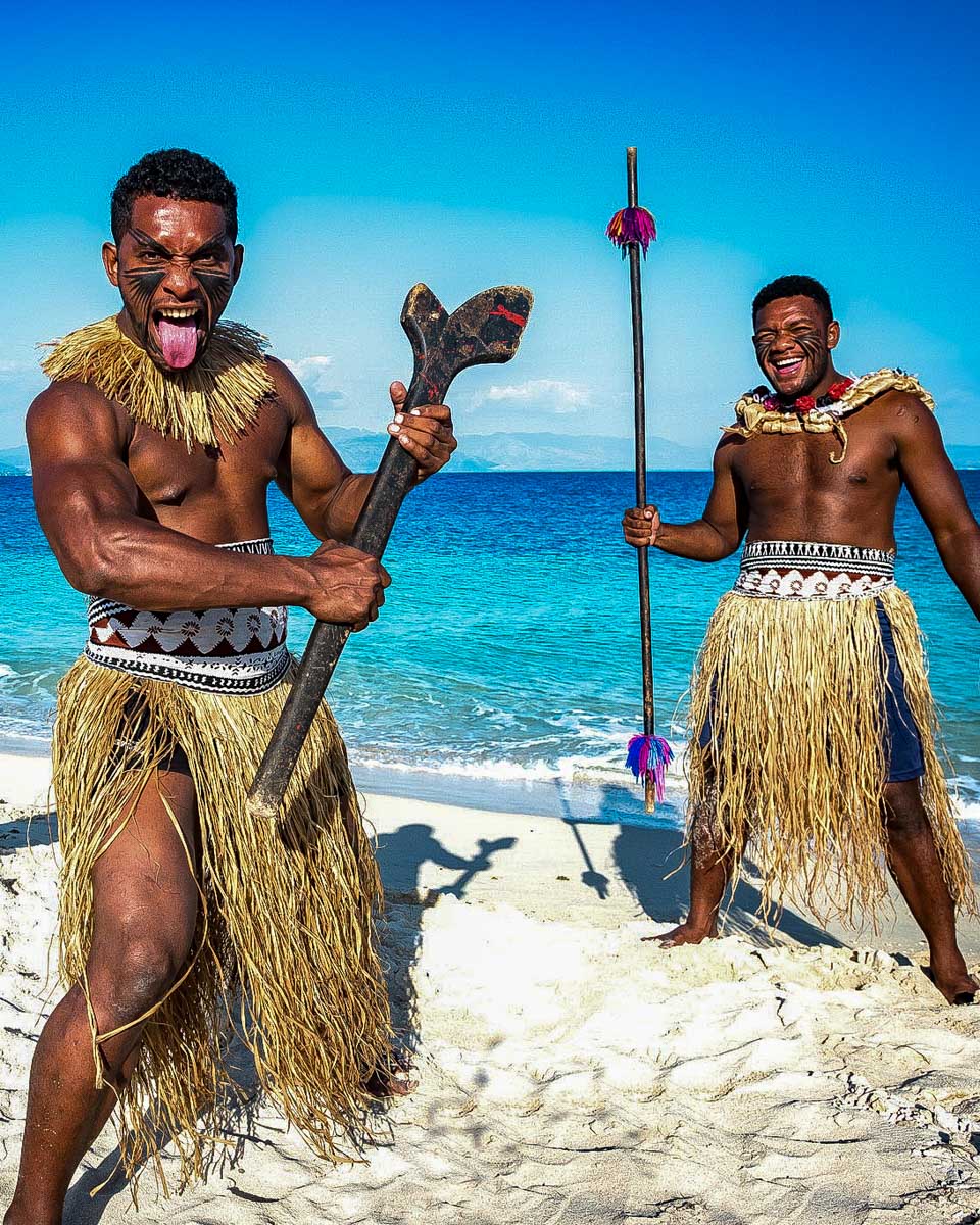 A Fijian man does a traditional dance on a multi day cruise in Fiji