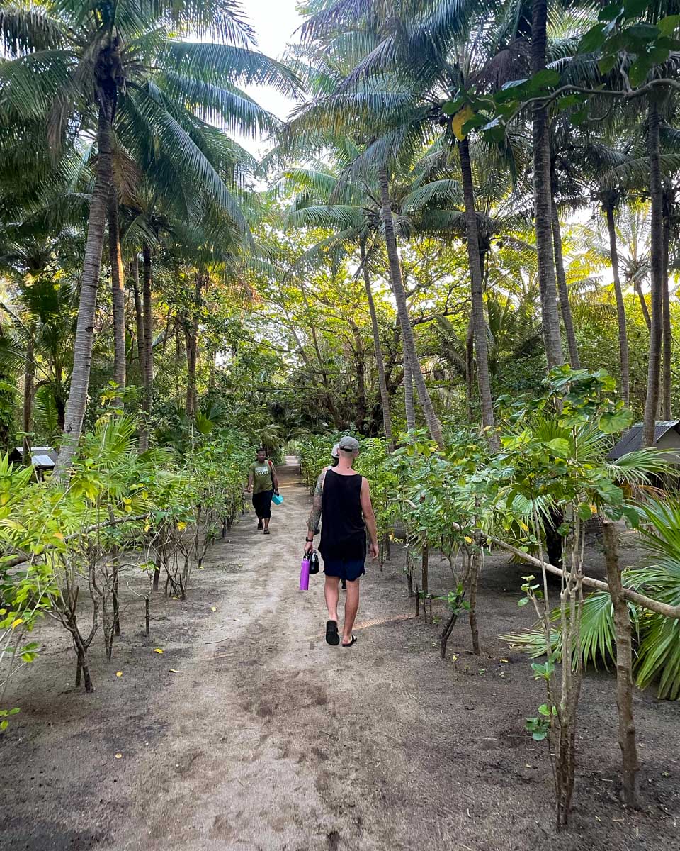 A man walks through the jungle at Waya Lailai Eco Haven Fiji