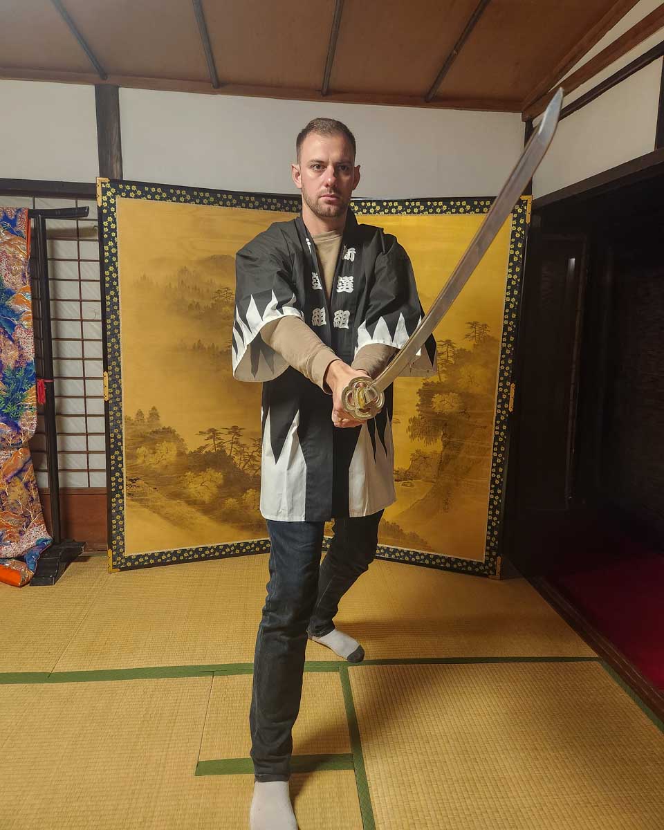 Daniel poses with a sword on a klook tour in Japan