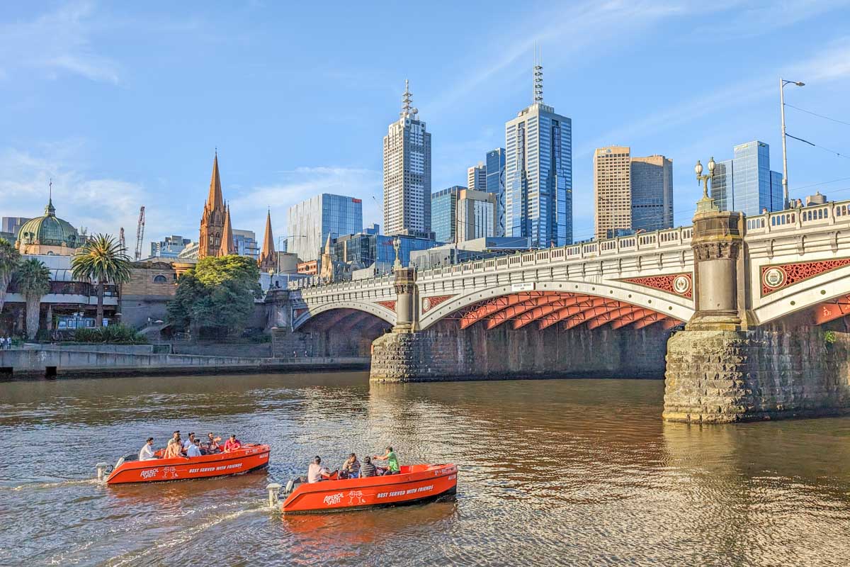 Two river boat rentals travel down the Yarra River in Melbourne City center