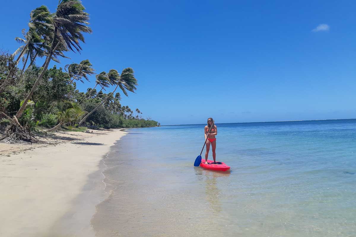 Bailey paddleboards on a multi day cruise in Fiji