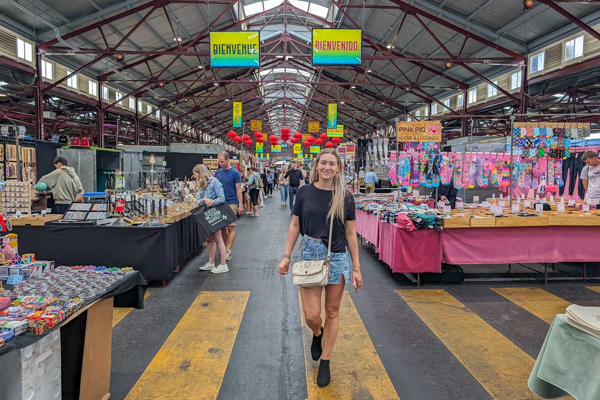 Bailey walks through the Queen Victoria Market in Melbourne Australia with things for sale