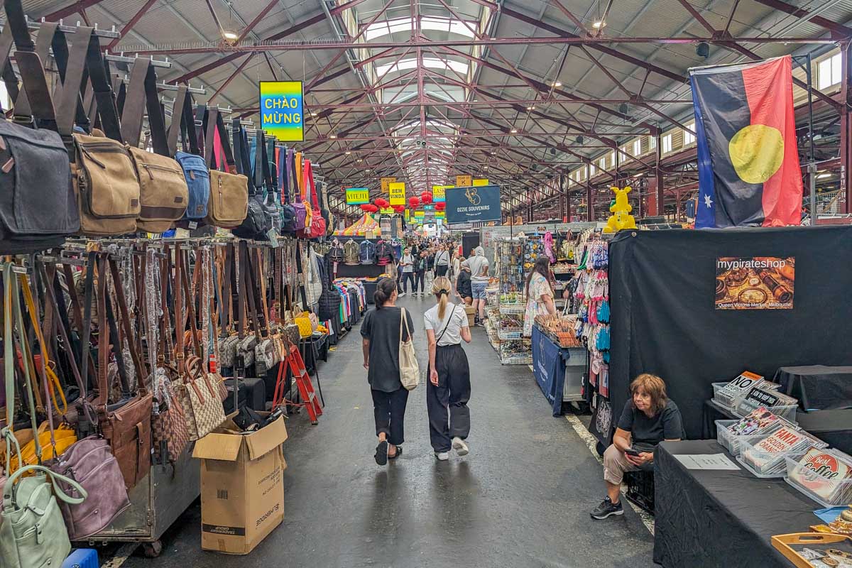 Two people walk through the Queen Victoria Market in Melbourne Australia