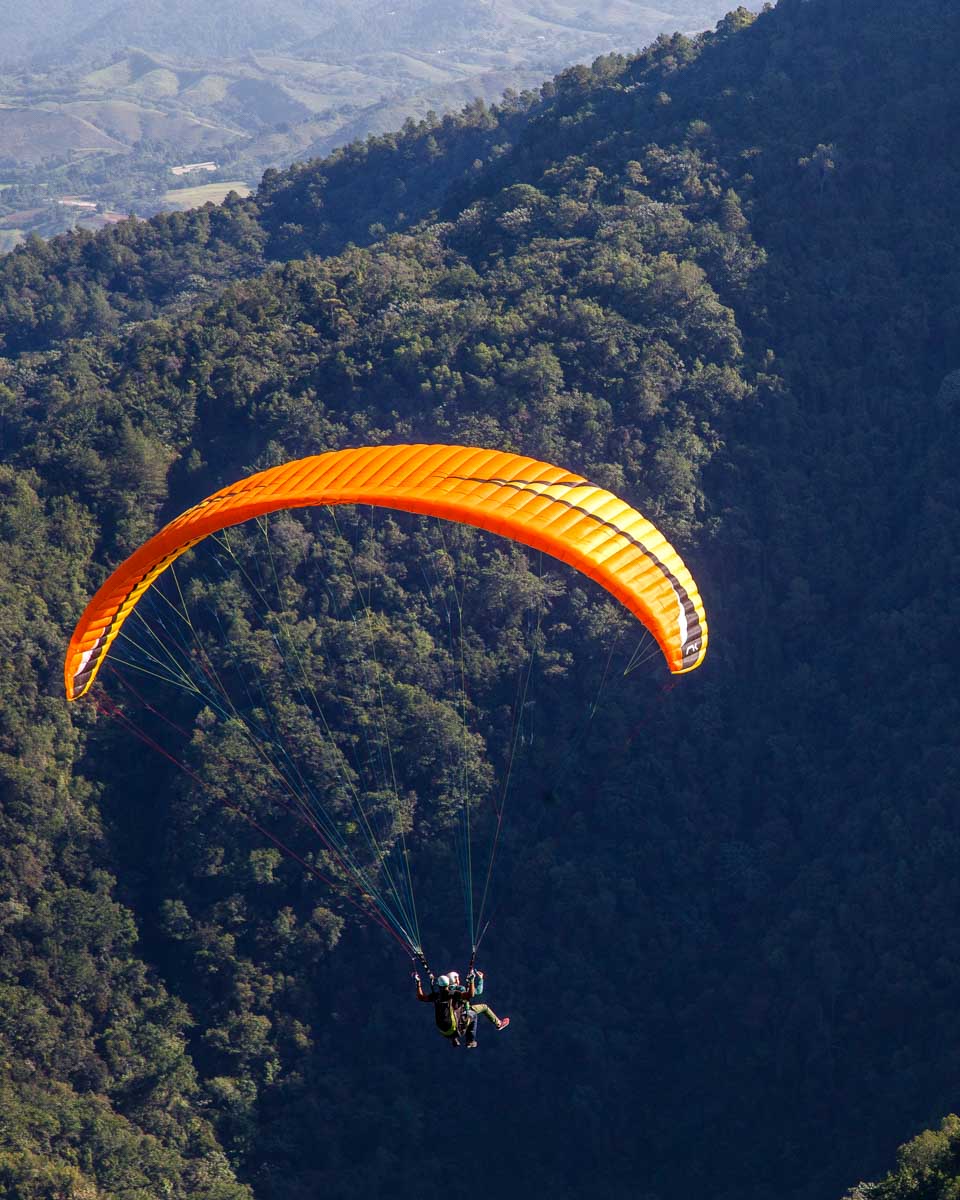 A person paraglides near Medellin Colombia jungle