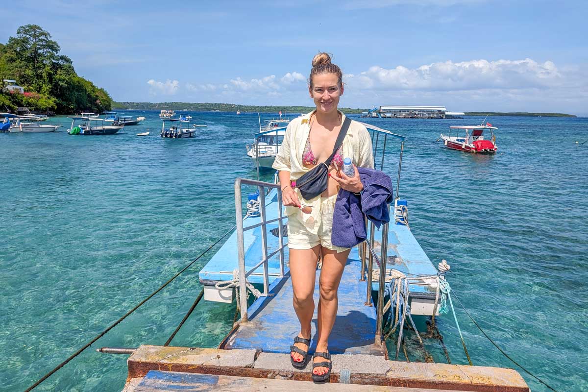 Bailey on a dock with the ocean behind her on a tour to Nusa Penida Bali