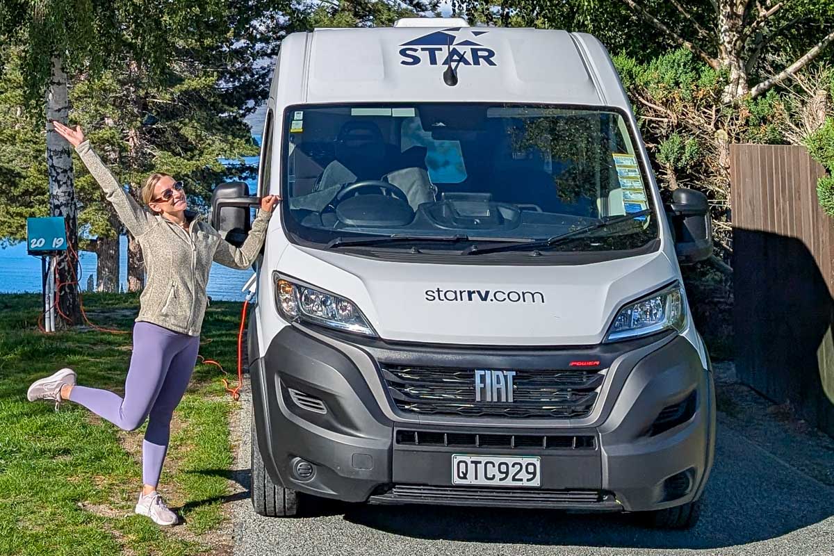 Bailey smiling stands with a Star RV campervan in New Zealand 2