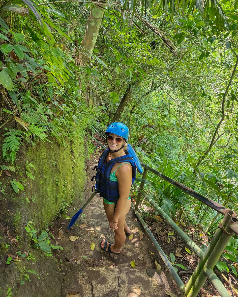 Bailey walking down stairs to a river for a rafting trip in Bali