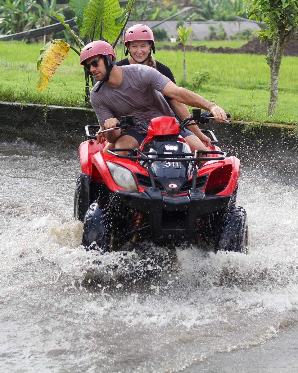 Daniel and Bailey ride an ATV through the water on a tour in Bali-2