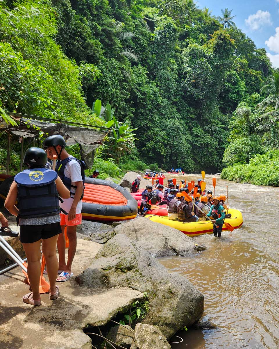Groups of people in raftes on a river in Bali