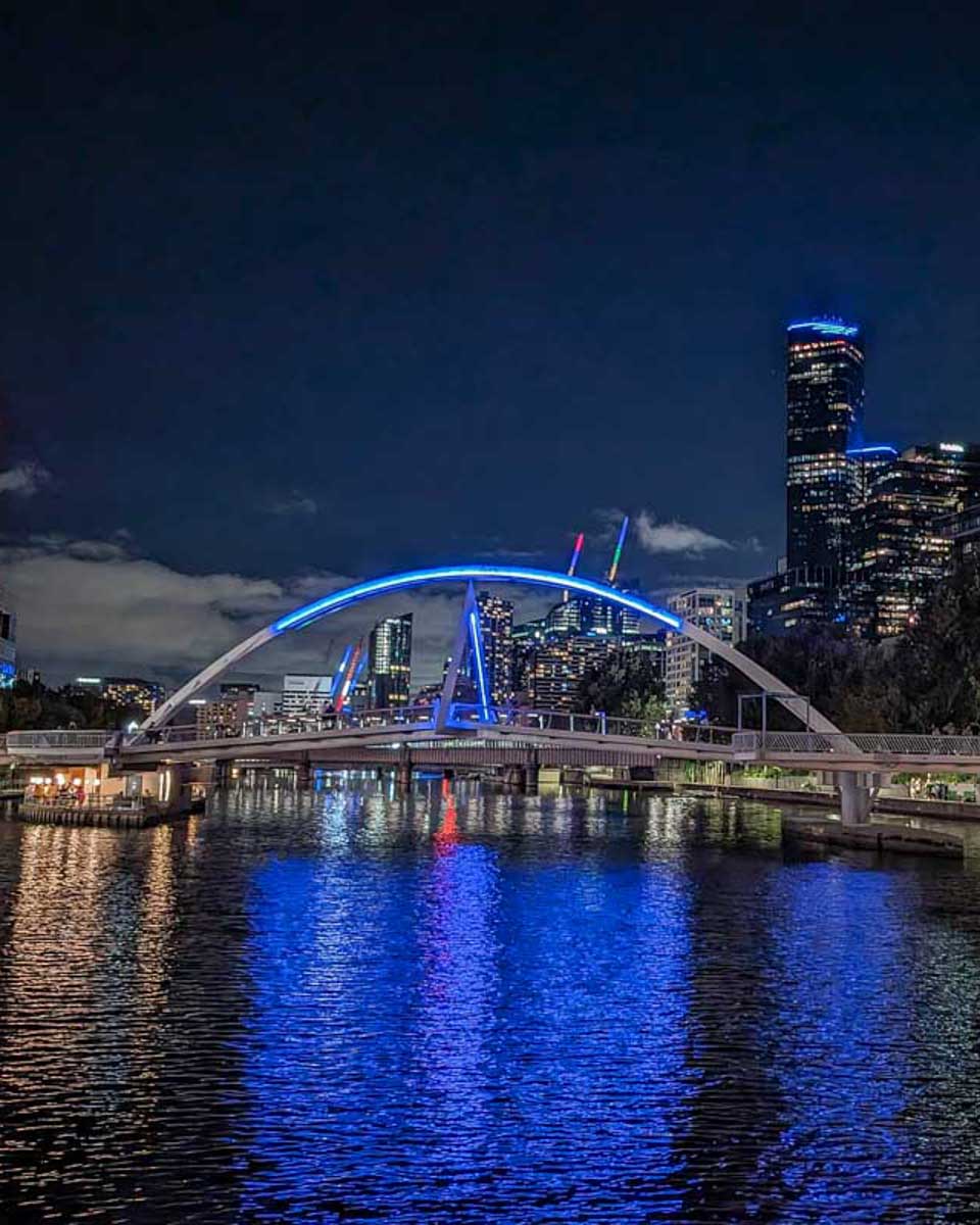 Melbourne-and-a-lit-bridge-at-night-on-the-spirit-of-melbourne-cruise