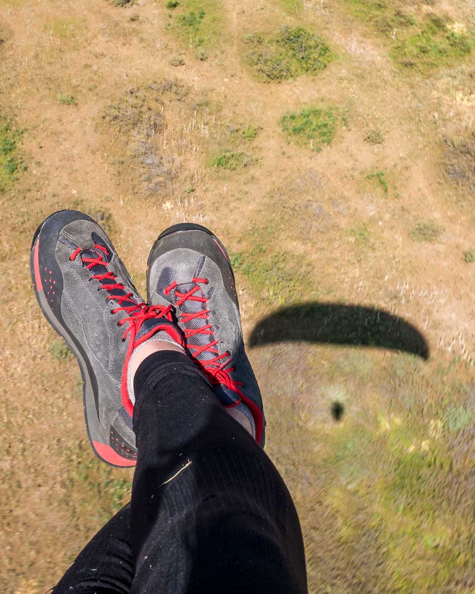 Paragliding feet in sky over Medellin Colombia