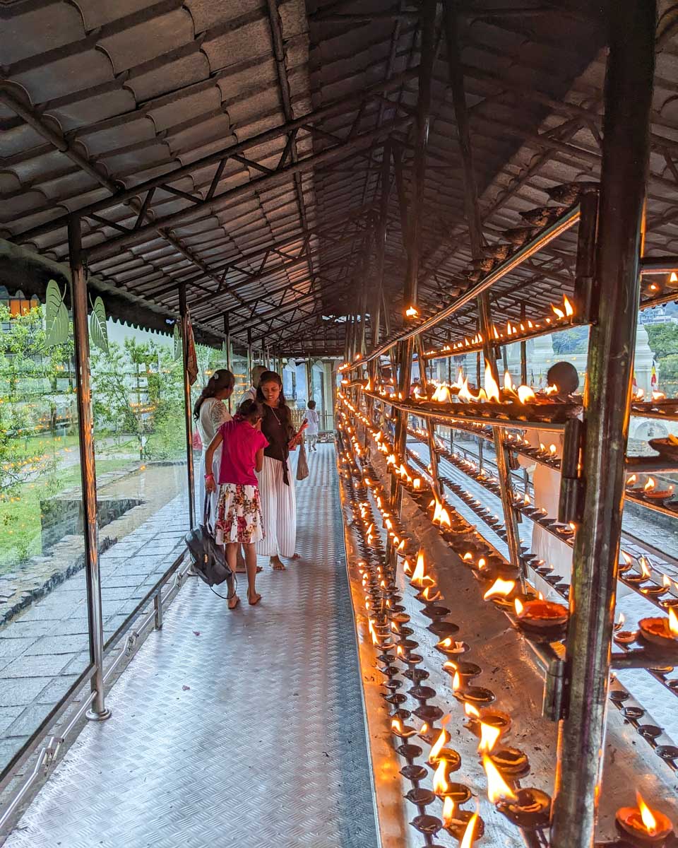 People inside of a shrine at the Sacred Tooth Temple in Kandy Sri Lanka