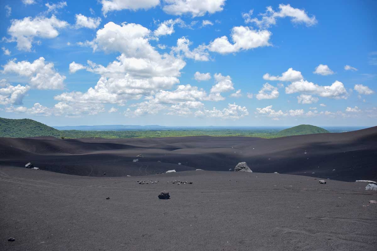 At the bottom of Cerro Negro looking at the landscape after volcano boarding in Nicaragua