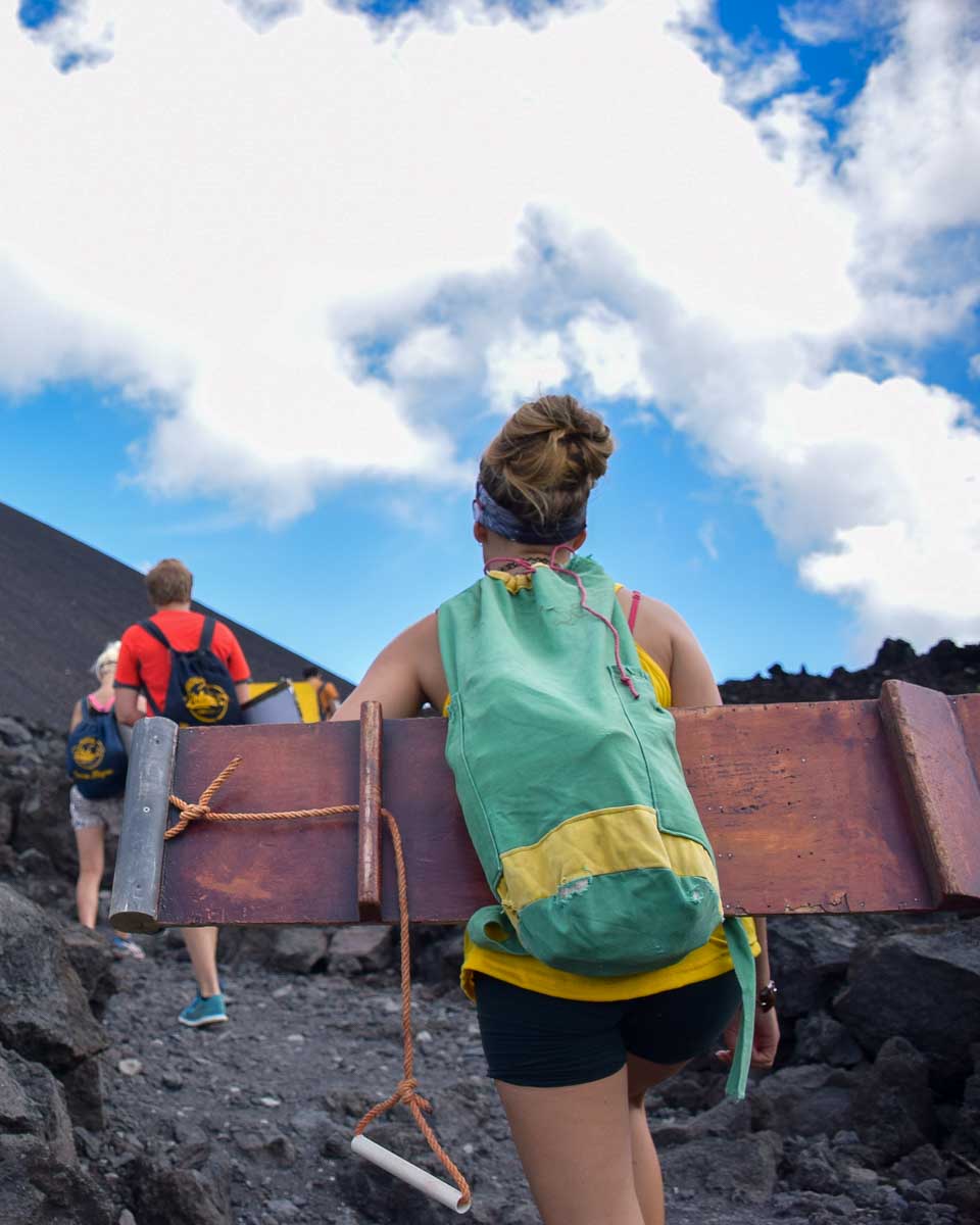 Bailey climbing Cerro Negro to volcano board in Nicaragua