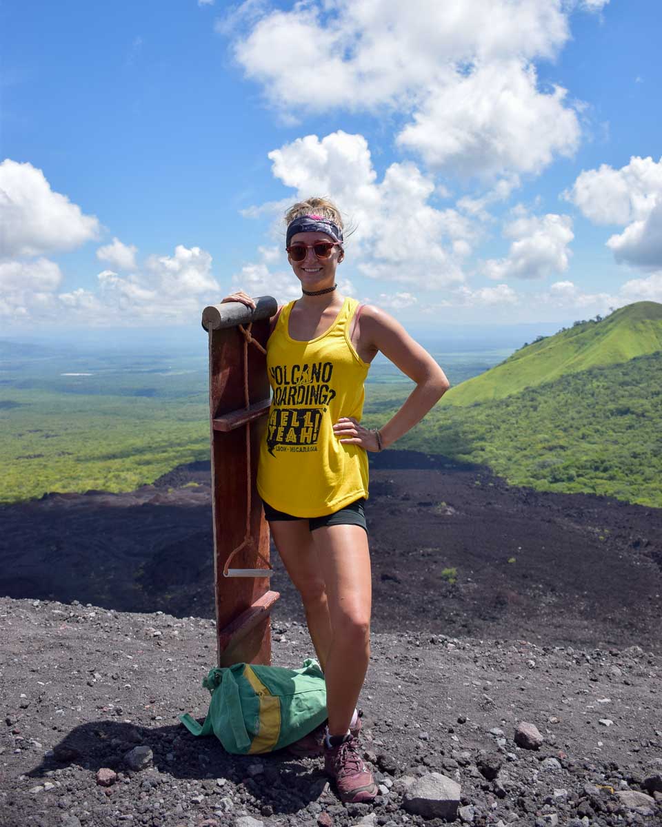 Bailey poses with her board and smiles at the top of Cerro Negro while volcano boarding in NIcaragua