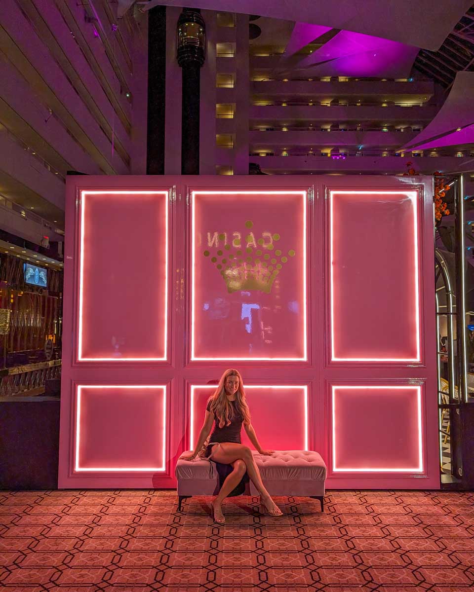 Bailey sits by a sign at Crown Towers Perth Australia
