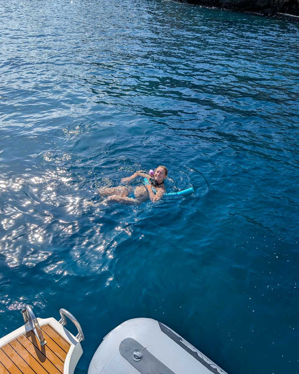 Bailey swims on a boat tour in Cefalu Itlay