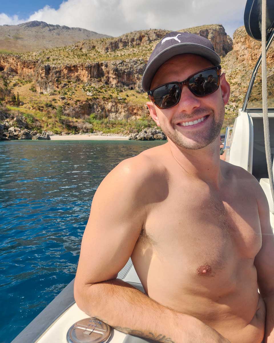 Daniel sits on a boat during a boat tour in Cefalu Italy