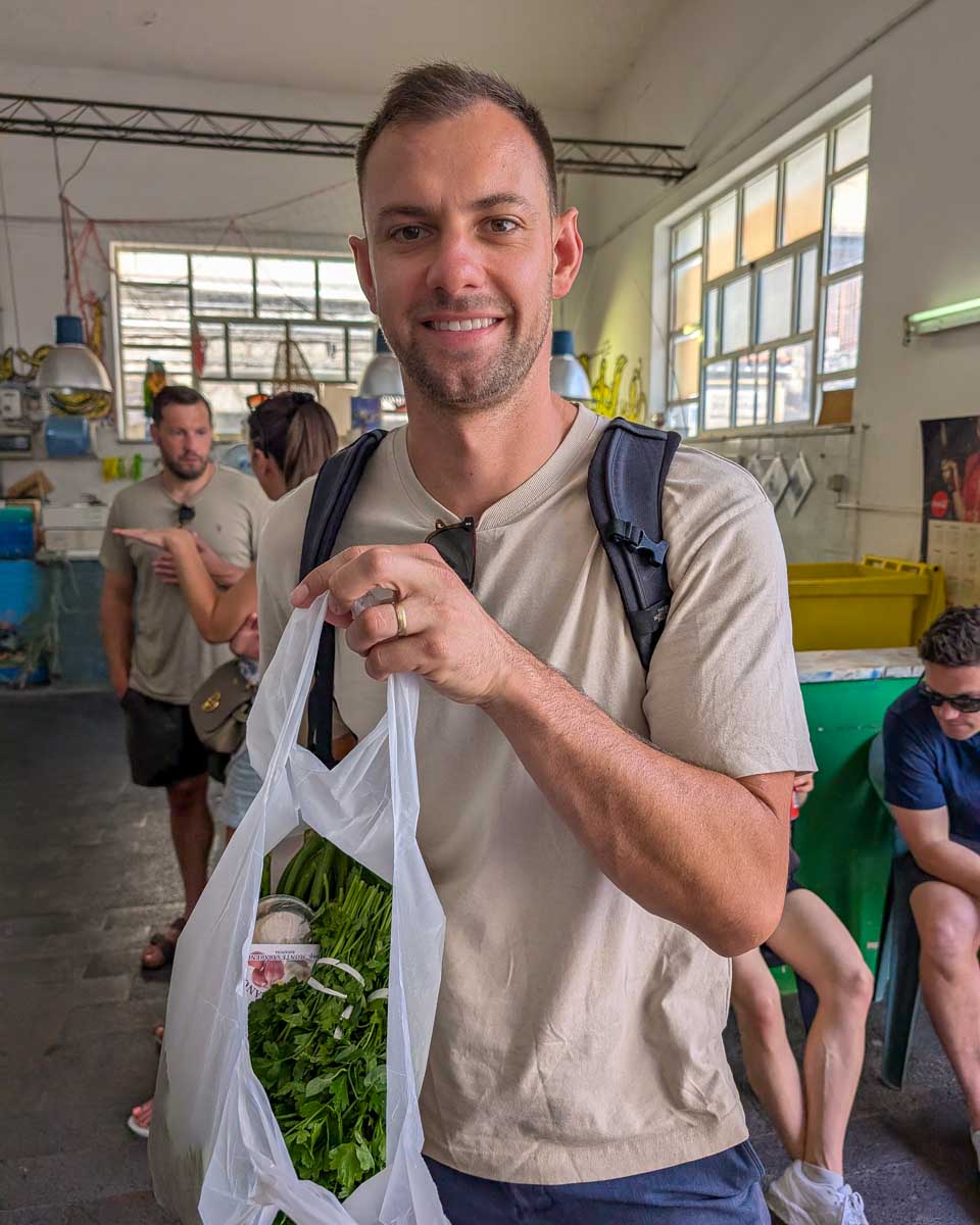 Daniel with fresh produce during a cooking class in Taormina Italy