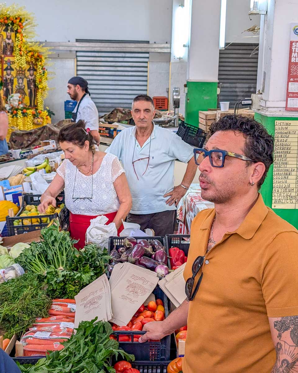People at a market during a cooking class in Taormina Italy