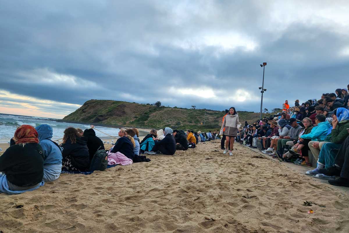 People sit on the beacch waiting for fairy penguins on Phillip Island Australia