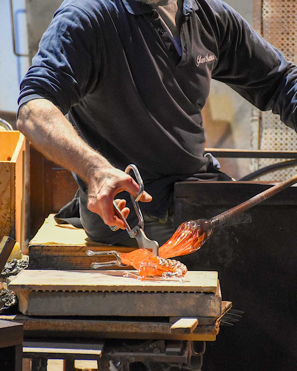 A man glass blowing a horse in Venice Italy