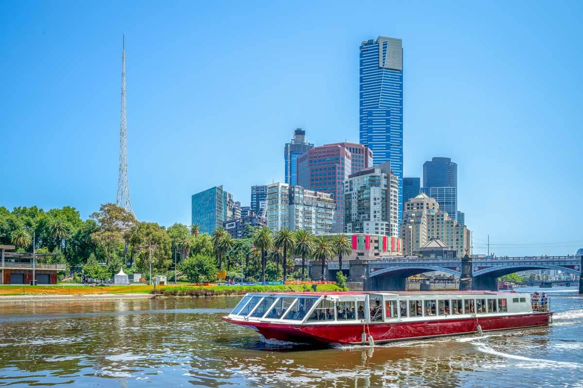 A river cruise and Melbourne skyline in Australia on a sunny day