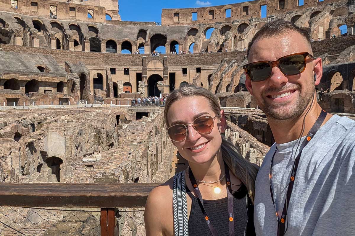Daniel and Bailey smile for a selfie in the colosseum of Rome Italy